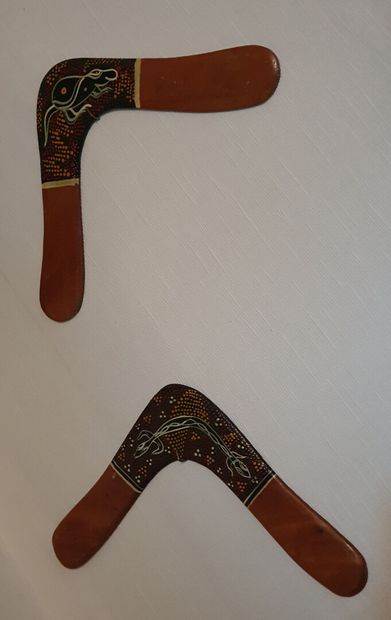 null Meeting of two aboriginal wooden BOOMERANGS partially painted with aboriginal...
