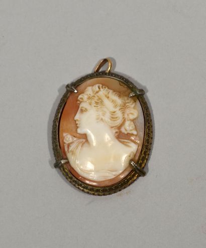 null A silver pendant with a shell cameo representing the bust of a young woman in...