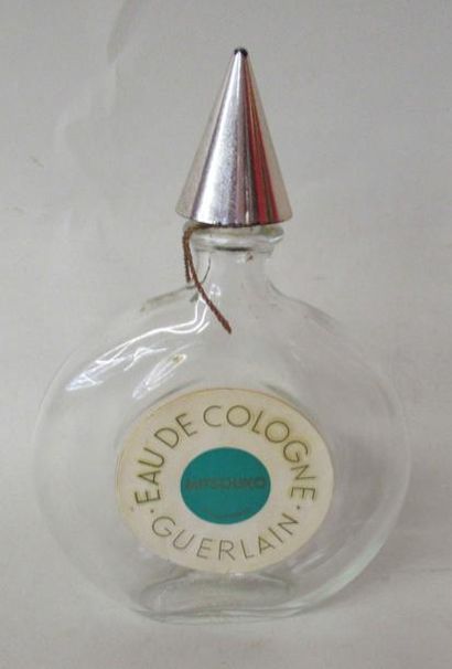 null GUERLAIN - Flacon à parfum modèle montre, à découpe circulaire et bouchon conique...