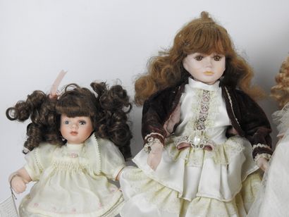null ENSEMBLE de cinq poupées, tête en porcelaine, trousseau en tissu, élégante en...