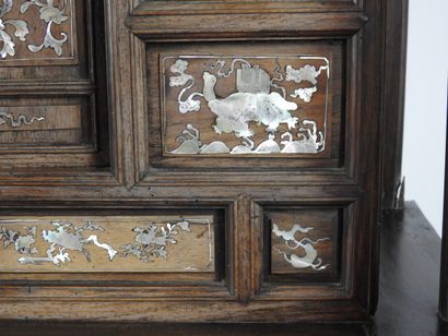 null Indochinese cabinet in exotic wood richly carved and inlaid with mother-of-pearl...