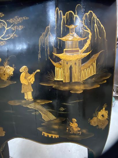  A COMMODE with gold varnish decoration of lacustrian landscapes animated with pagodas...