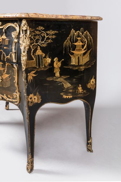  A COMMODE with gold varnish decoration of lacustrian landscapes animated with pagodas...
