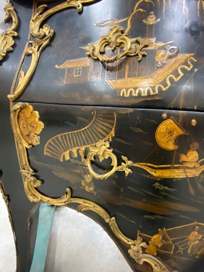 null A COMMODE with gold varnish decoration of lacustrian landscapes animated with...