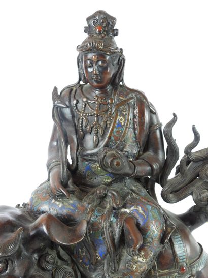 null CHINA: Guanyin riding a Fö dog in patinated bronze, cloisonné enamel and stone...