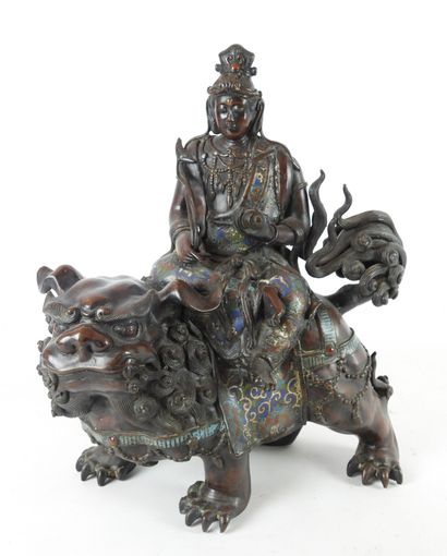 null CHINA: Guanyin riding a Fö dog in patinated bronze, cloisonné enamel and stone...