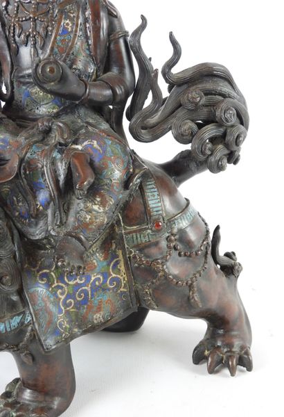 null CHINA: Guanyin riding a Fö dog in patinated bronze, cloisonné enamel and stone...