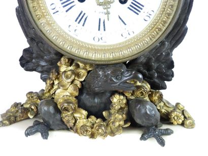 null A gilt bronze and patinated eagle clock, the circular white enamelled dial signed...