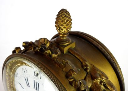 null A gilt bronze and patinated eagle clock, the circular white enamelled dial signed...