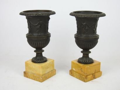 null Pair of Medici vases in chased and patinated bronze with a farandole of satyrs...