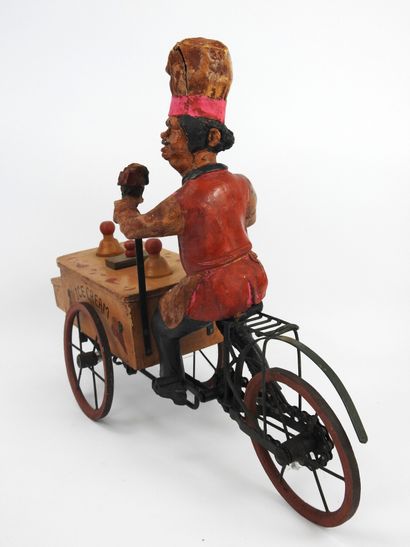 null TOY representing an ice cream merchant in painted paper maché, ice cream cart...
