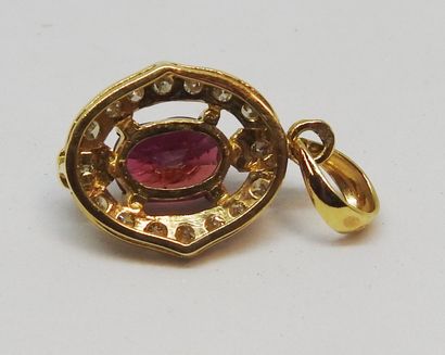 null Pendant in 18K yellow gold (750 thousandths) set with an oval cut ruby, in an...