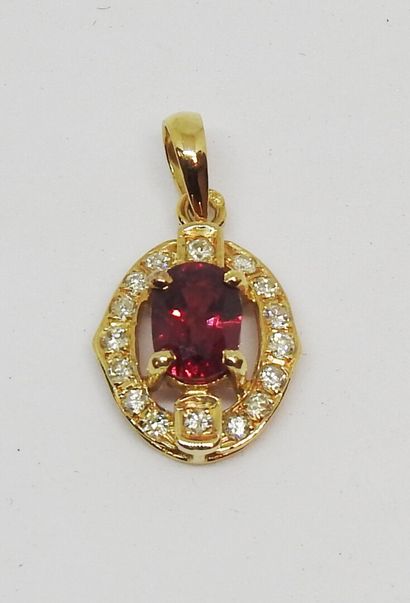 null Pendant in 18K yellow gold (750 thousandths) set with an oval cut ruby, in an...