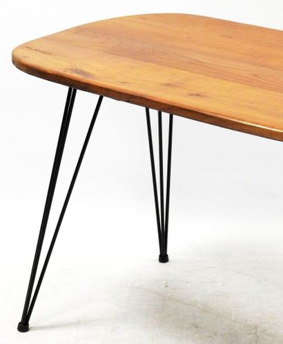 null Dining room table with free-form top in natural wood resting on a tripod base...