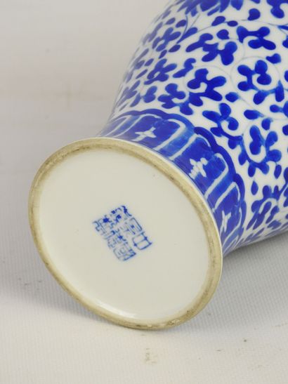 null CHINA. Porcelain vase of baluster form with white-blue decoration of foliage....