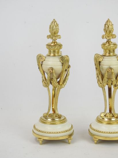 null Pair of CASSOLETTES forming candlesticks, in white marble and chased and gilded...