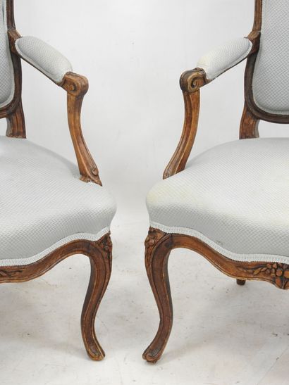 null Pair of beechwood armchairs, molded and carved with flat backs, they rest on...