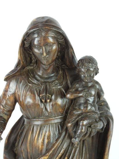 null Sculpture in walnut representing the Virgin Mary carrying the baby Jesus on...