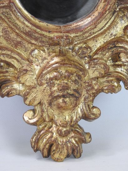 null Mirror in carved and gilded wood decorated with rocaille, flowers and mascaron....