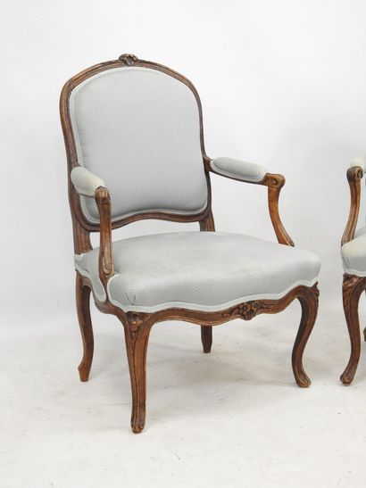 null Pair of beechwood armchairs, molded and carved with flat backs, they rest on...