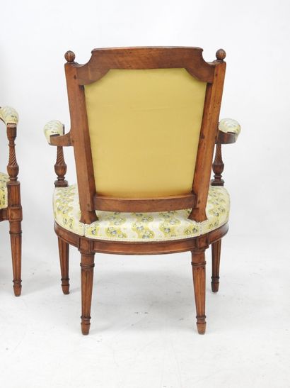 null Pair of cabriolet armchairs, with "gendarme hat" backs decorated with pomegranates,...