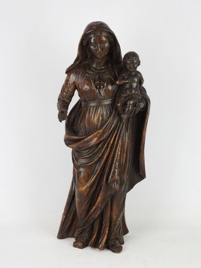 null Sculpture in walnut representing the Virgin Mary carrying the baby Jesus on...