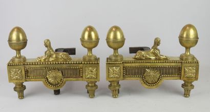 null PAIR OF CHENETS in chased and gilded bronze decorated with stylized pine cones,...