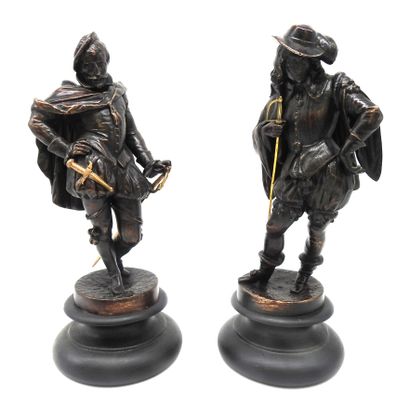 STATUETTES. Pair of regules with bronze patina...
