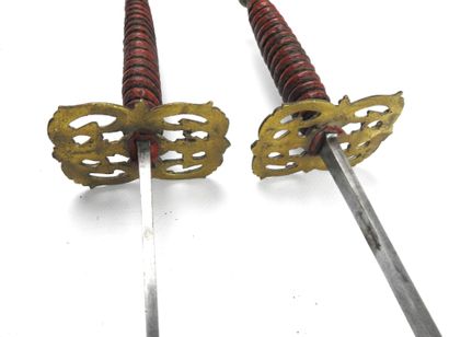 null FENCING. Pair of foils with cigar-shaped wooden handles covered with red leather...