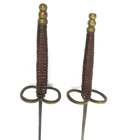null FENCING. Pair of foils with cigar-shaped wooden handles covered with red leather...