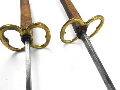 null FENCING. Pair of foils with wooden handles covered with fine cord, small spherical...