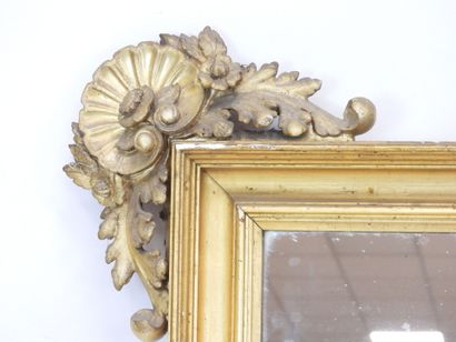 null Wood and gilded stucco mirror decorated with shells and flowers in the spandrels,...