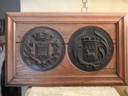 Oak frame with two medallions with city coats...