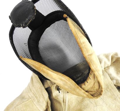 null FENCING. Complete fencer's outfit circa 1920-1930 including a small mesh mask...