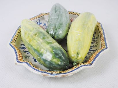 null Polychrome earthenware dish with trompe l'oeil decoration of three cucumbers....