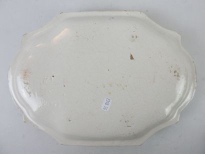 null Polychrome earthenware dish with trompe l'oeil decoration of three cucumbers....