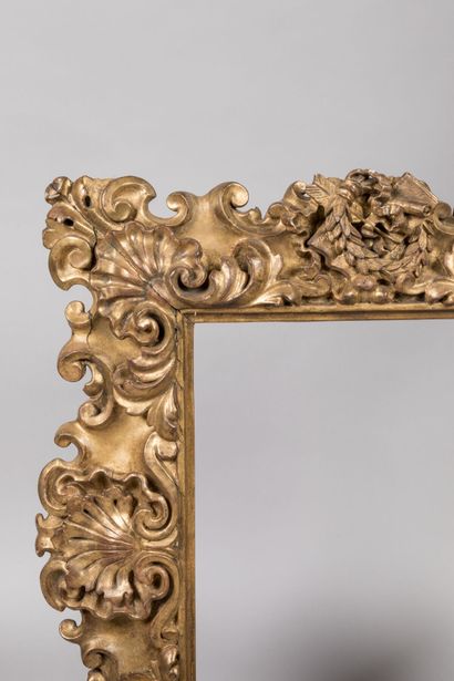 null Bare frame in molded and gilded wood with rich decoration of shells and attributes...