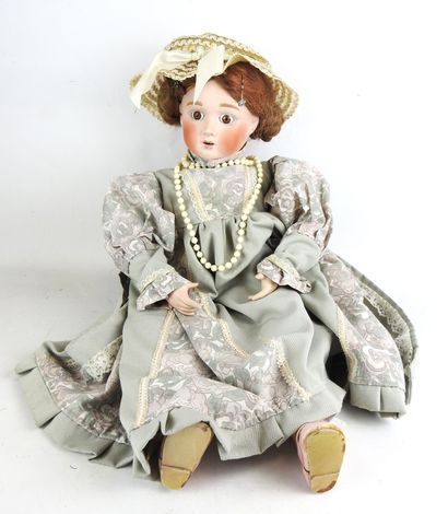 null Porcelain doll with brown eyes, open mouth and porcelain body. Mark HM 14.91....