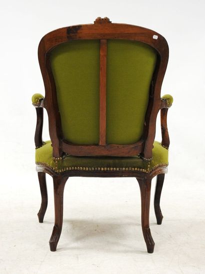 null Cabriolet armchair in molded and carved beech, green velvet upholstery.
Louis...