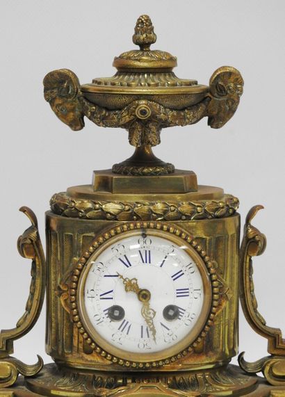 null Gilt bronze mantelpiece including a clock topped by a covered pot flanked by...