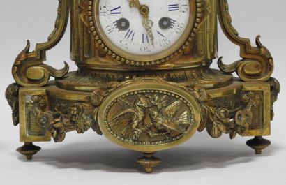null Gilt bronze mantelpiece including a clock topped by a covered pot flanked by...