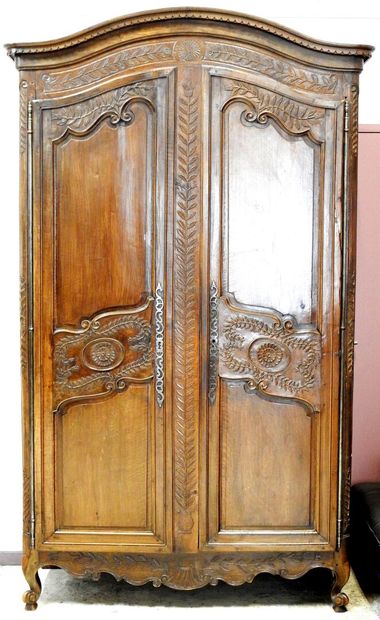 null Arched cabinet in natural wood opening by two doors in front decorated with...