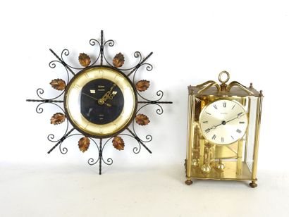 null TROPHY: Wrought-iron clock with foliate decoration, dial with Arabic numerals....