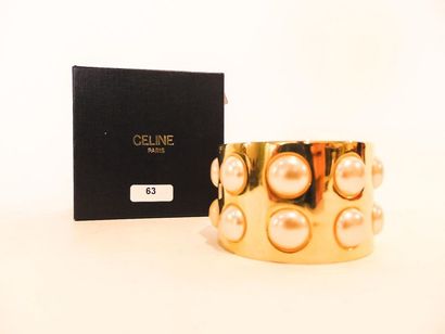 CELINE - PARIS Bracelet-manchette en métal doré pavé de demi-perles, marqué, avec...