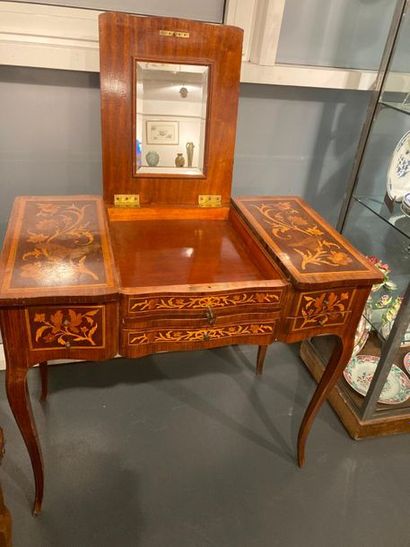 null Louis XV style dressing table opening with a tripartite broken top revealing...