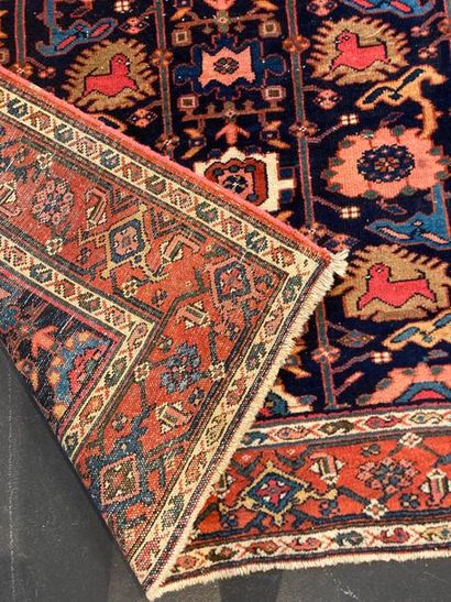 null Bakhtiar-style Persian carpet with stylized polychrome motifs on a midnight-blue...
