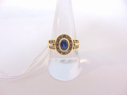 null Ring in 18 karat yellow gold set with an oval sapphire surrounded and shouldered...