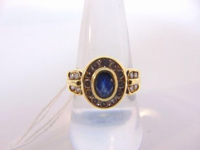 null Ring in 18 karat yellow gold set with an oval sapphire surrounded and shouldered...