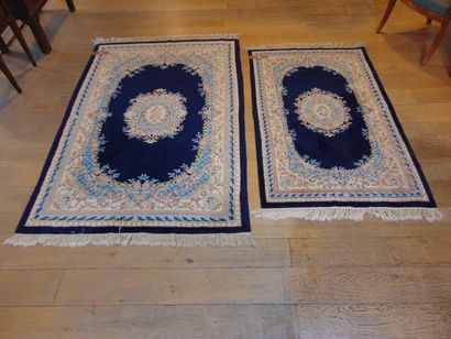 null Two Kerman-style Nepalese rugs with central medallion on indigo field, 196x123...
