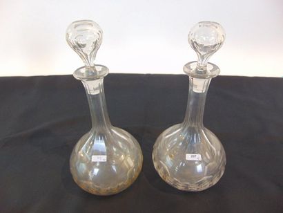 null Pair of carafes, late 19th century, cut glass, h. 31 cm; a matching carafe is...